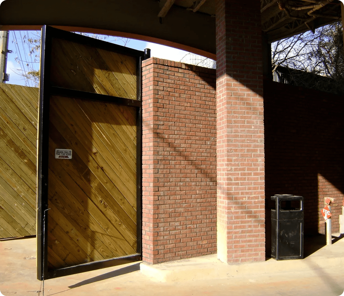 Wooden gate and brick wall entrance