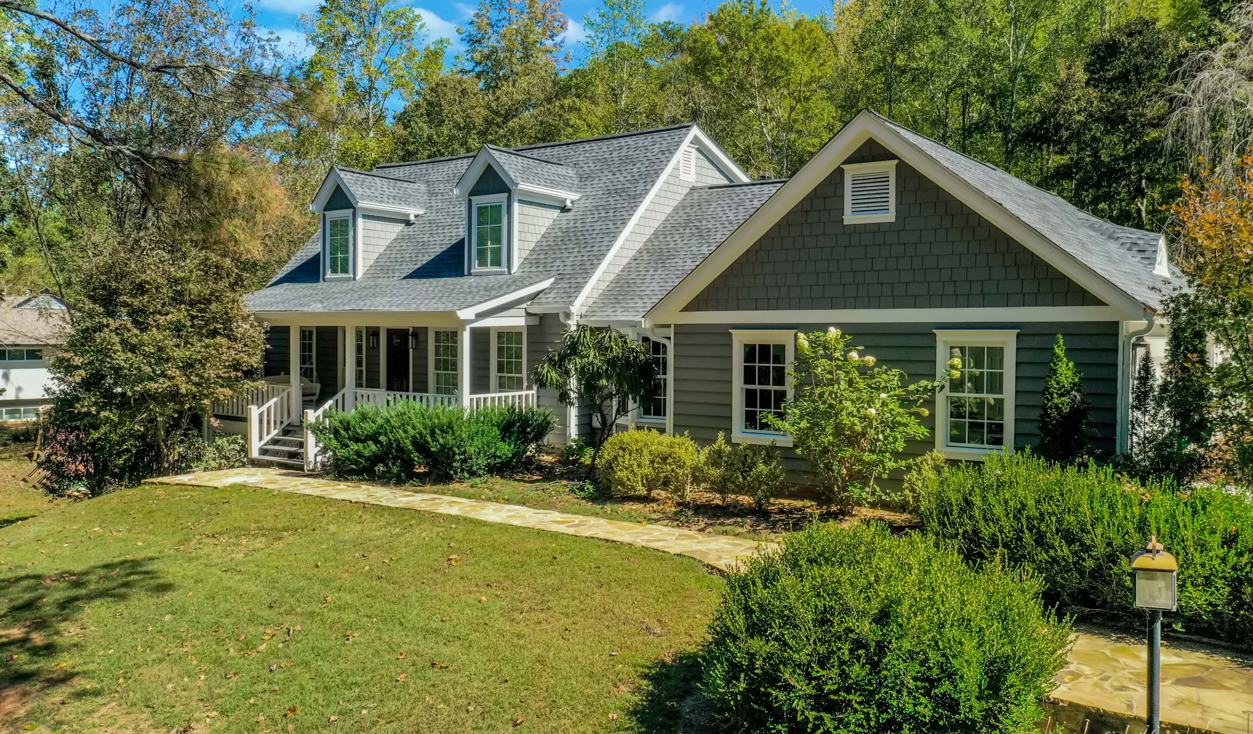 Green lawn and cozy porch house