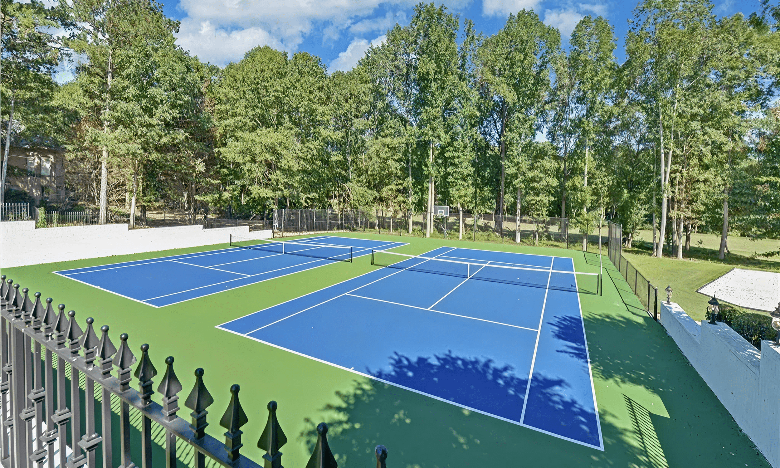 Tennis courts in a wooded area